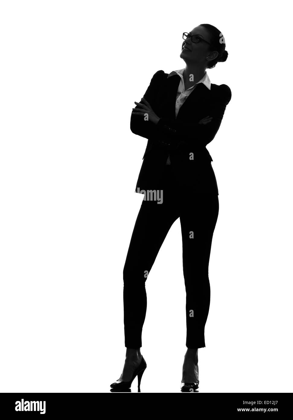 Une business woman standing looking up smiling en silhouette sur fond blanc Banque D'Images Une business woman standing looking up smiling en silhouette sur fond blanc Banque D'Images