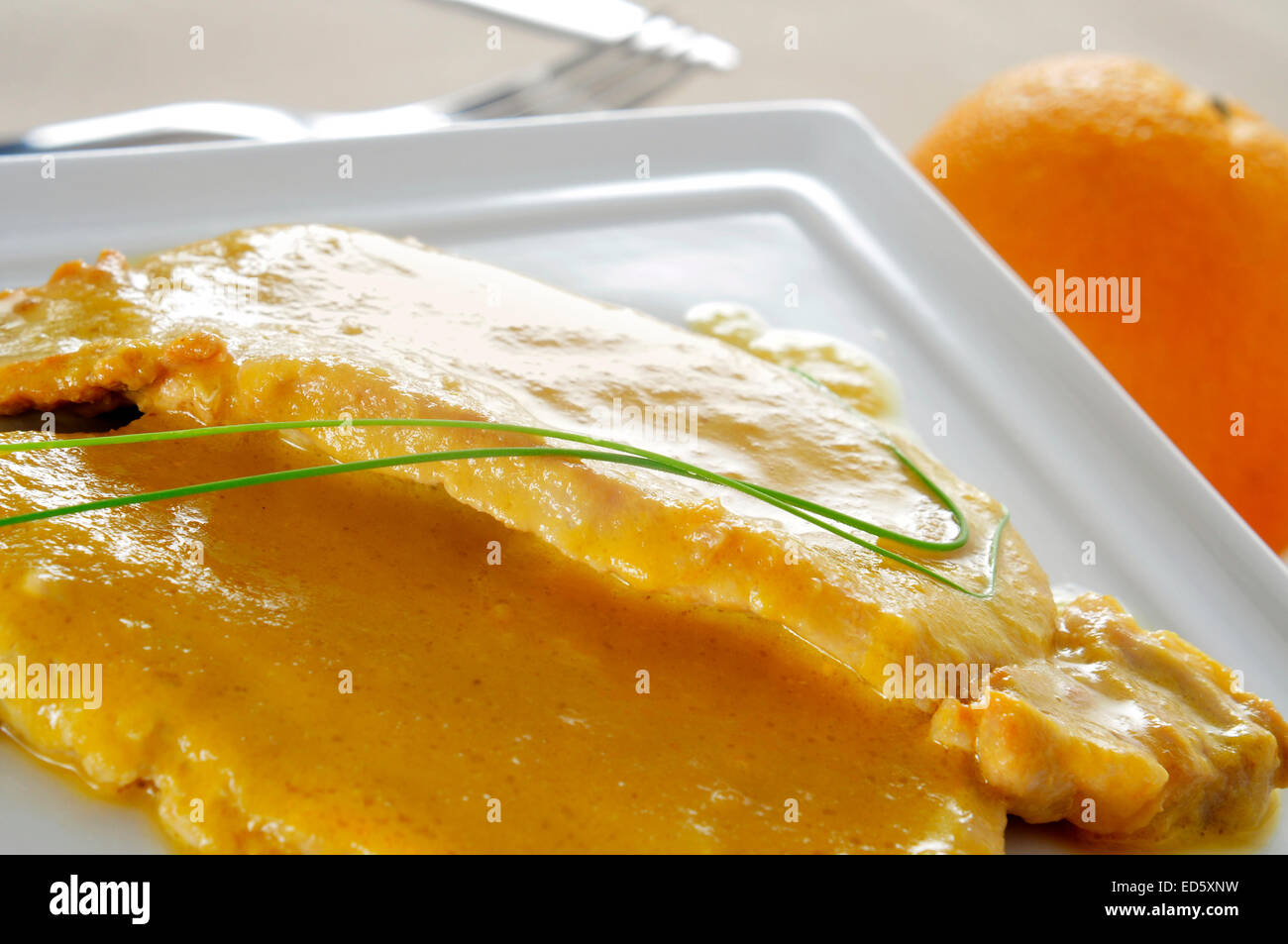 Une assiette avec quelques tranches de surlonge de porc à l'orange Banque D'Images