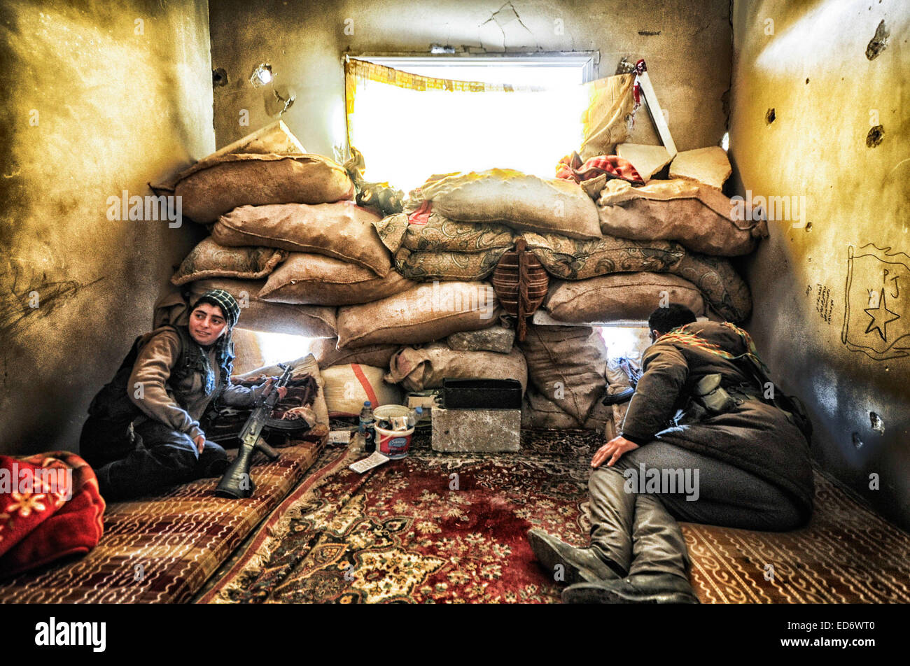 Kobane, la Syrie. Dec 21, 2014. Pompiers en Kobane des positions de l'homme à l'appui de l'avancement des troupes au sol dans la bataille pour l'Kobane contre l'Etat islamique. Les forces kurdes sont entièrement l'intégré. Les combattants féminins montrent beaucoup d'humilité et de l'efficacité en tant que membres dans la lutte pour la survie de leur pays. © Gail Orenstein/ZUMA/Alamy Fil Live News Banque D'Images