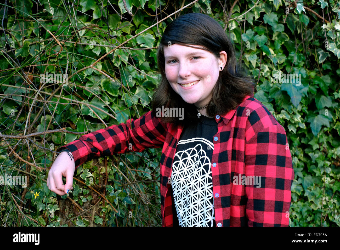 Douze ans smiling girl qui pose pour un portrait dans le jardin de la famille Banque D'Images