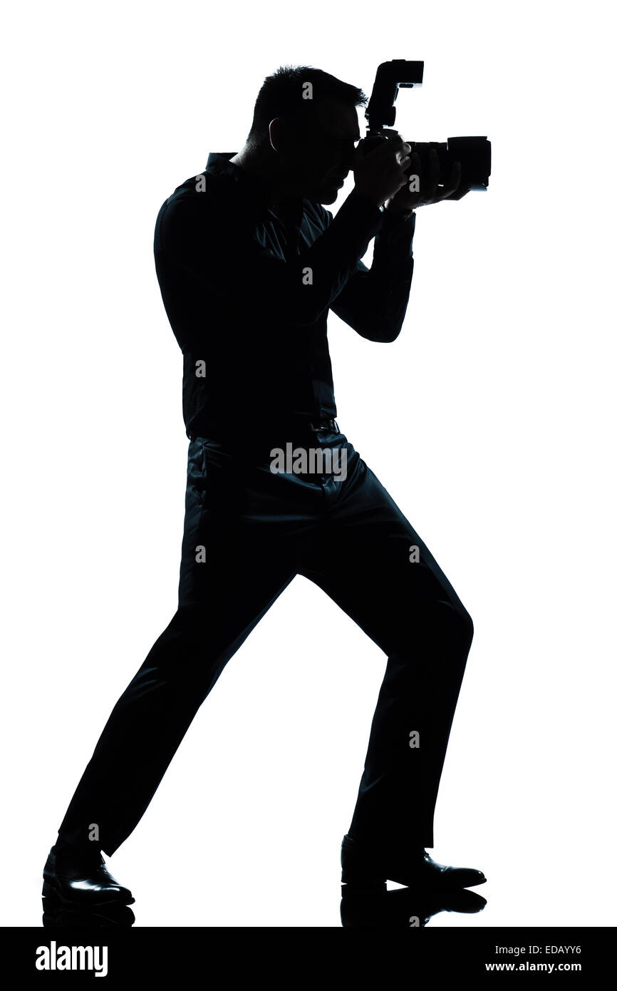 Un homme de race blanche silhouette en pleine longueur photographe studio isolé sur fond blanc Banque D'Images