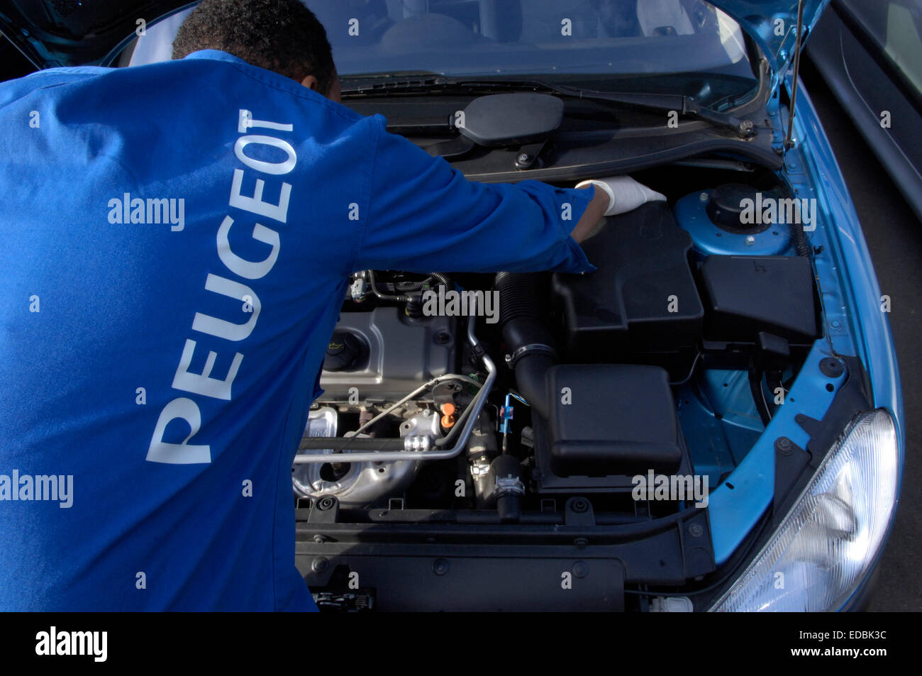 Un mécanicien de voiture au travail sur Peugeot 206. Banque D'Images