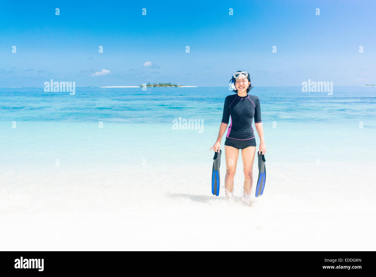 Les Maldives, Ari Atoll, jeune femme diver venant hors de l'eau Banque D'Images