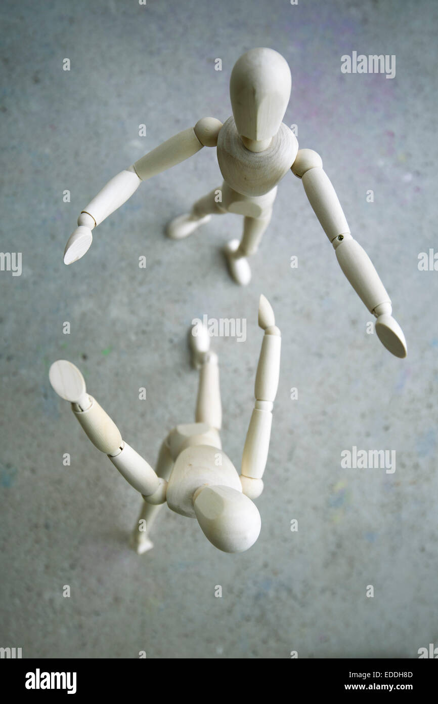 Deux mannequins en bois debout sur sol gris Banque D'Images