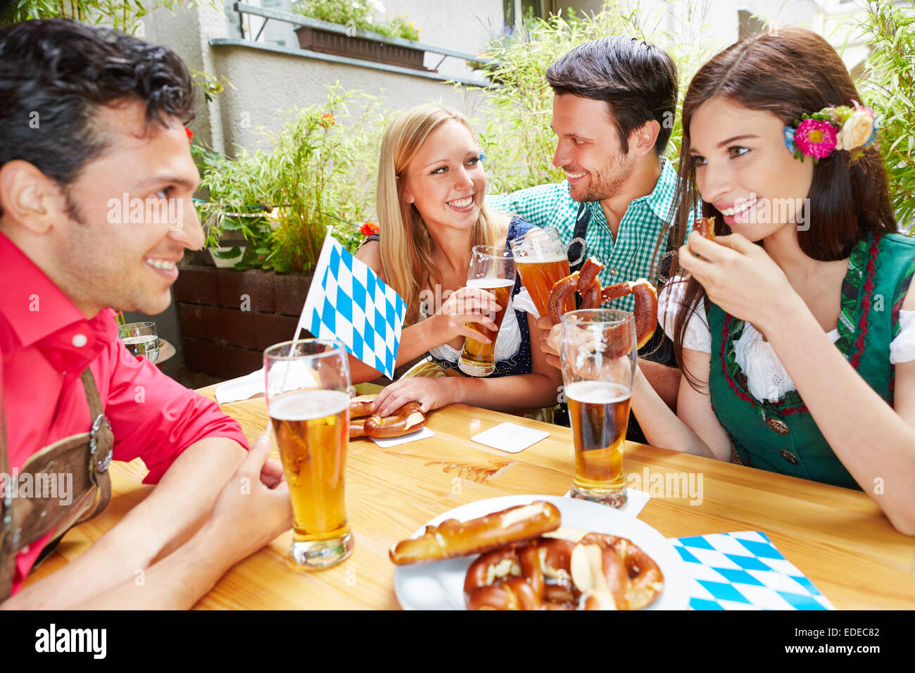 Happy friends talking and flirting in beer jardin en été Banque D'Images
