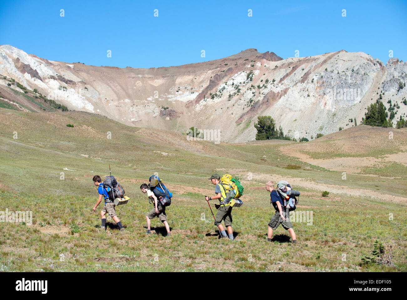 Groupe de garçons plus de sac à dos dans l'Eagle Pass Tenderfoot Cap désert le jour 2 de leur trek. Banque D'Images