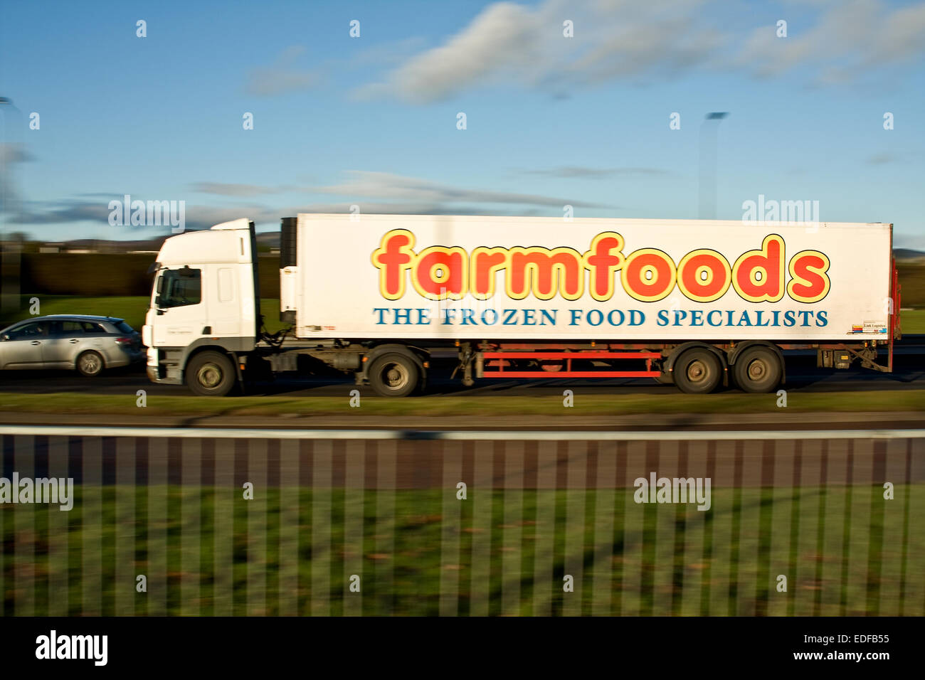 Défilement d'une Farmfoods avec camions synchro flash arrière voyageant le long de la route à l'ouest de Kingsway à Dundee, Royaume-Uni Banque D'Images