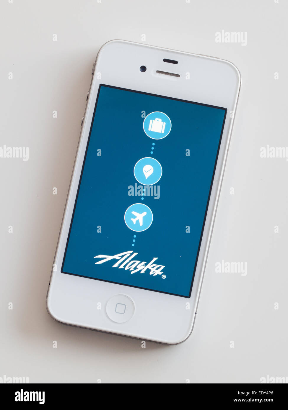 L'écran d'accueil de l'Alaska Airlines mobile app sur un Apple iPhone 4 blanc. Banque D'Images