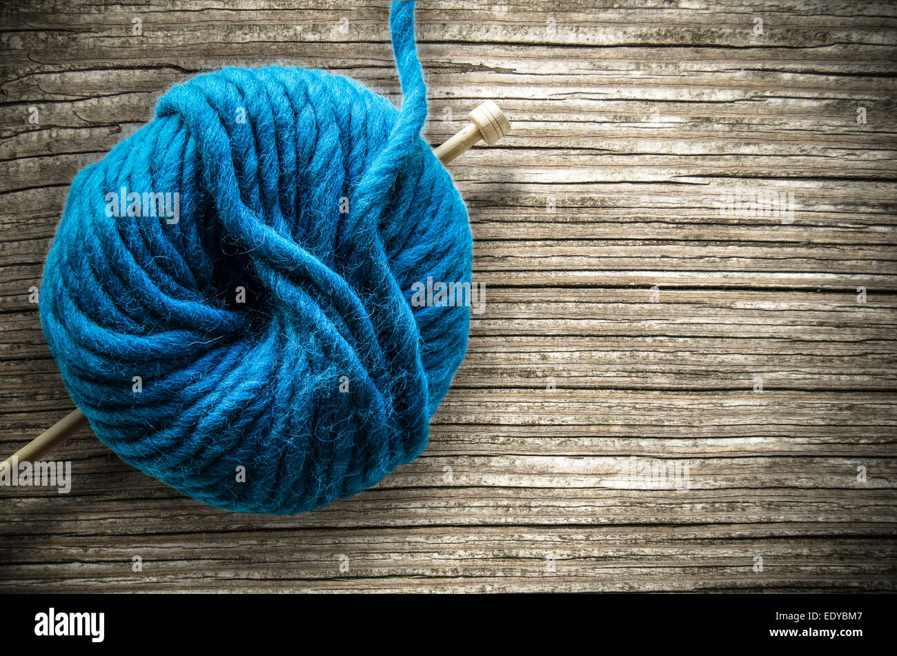 Balle de laine et aiguille à tricoter sur une table en bois Banque D'Images