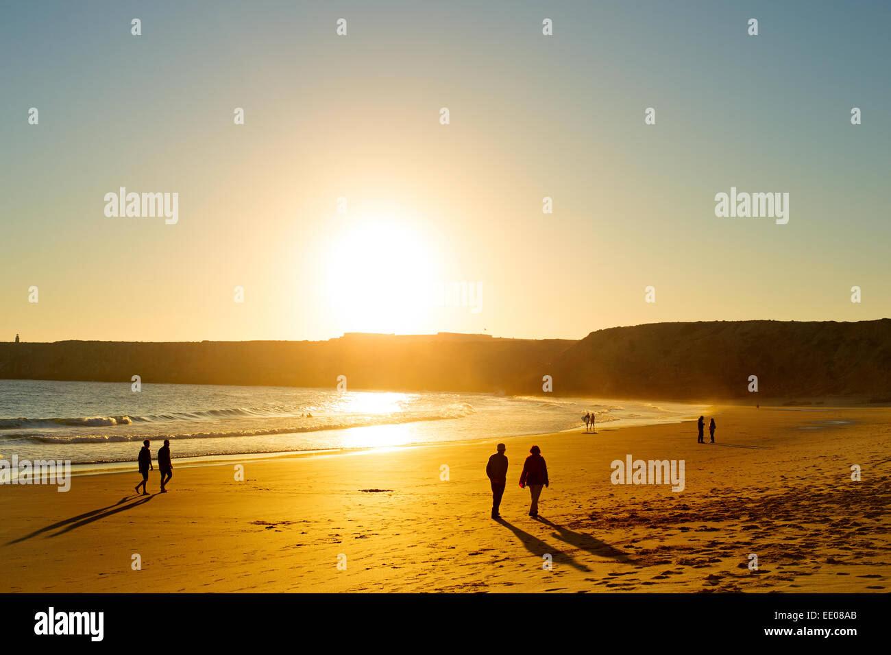 Les gens qui marchent à la méconnaissable plage au coucher du soleil. Sagers, Algarve, Portugal Banque D'Images