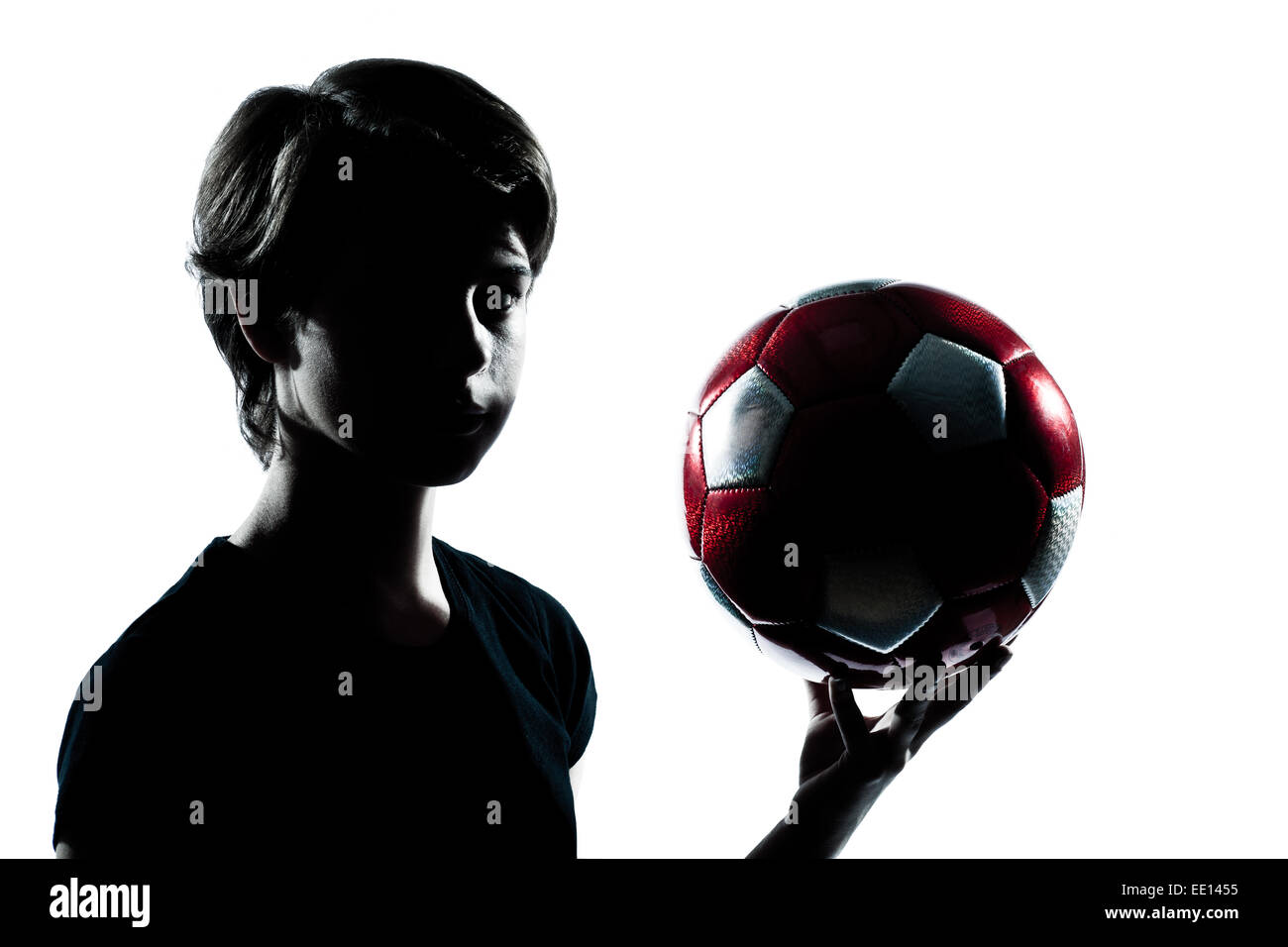 Portrait d'un jeune adolescent silhouette garçon fille holding football soccer montrant portrait en studio cut out isolé sur fond blanc Banque D'Images