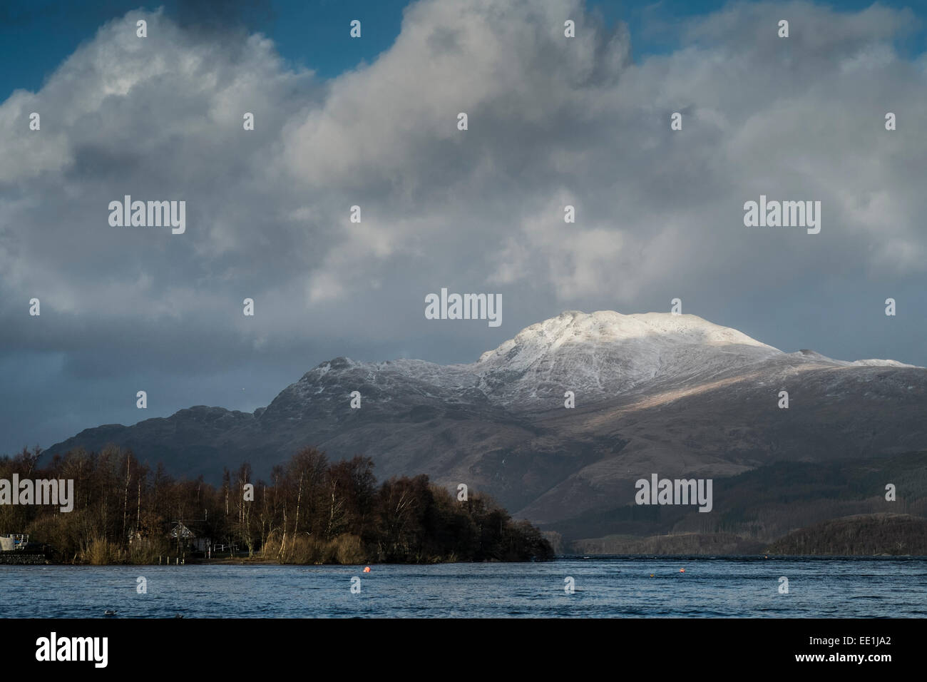 La neige recouvre le haut de Ben Lomond sur les rives du Loch Lomond, Ecosse. Banque D'Images