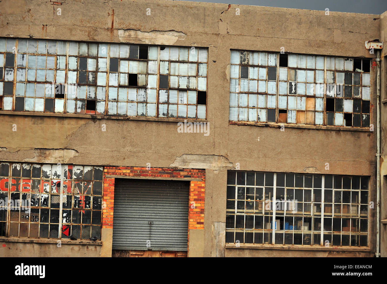 Brisé des fenêtres sur un entrepôt à l'abandon dans le centre de Johannesburg en Afrique du Sud. Banque D'Images