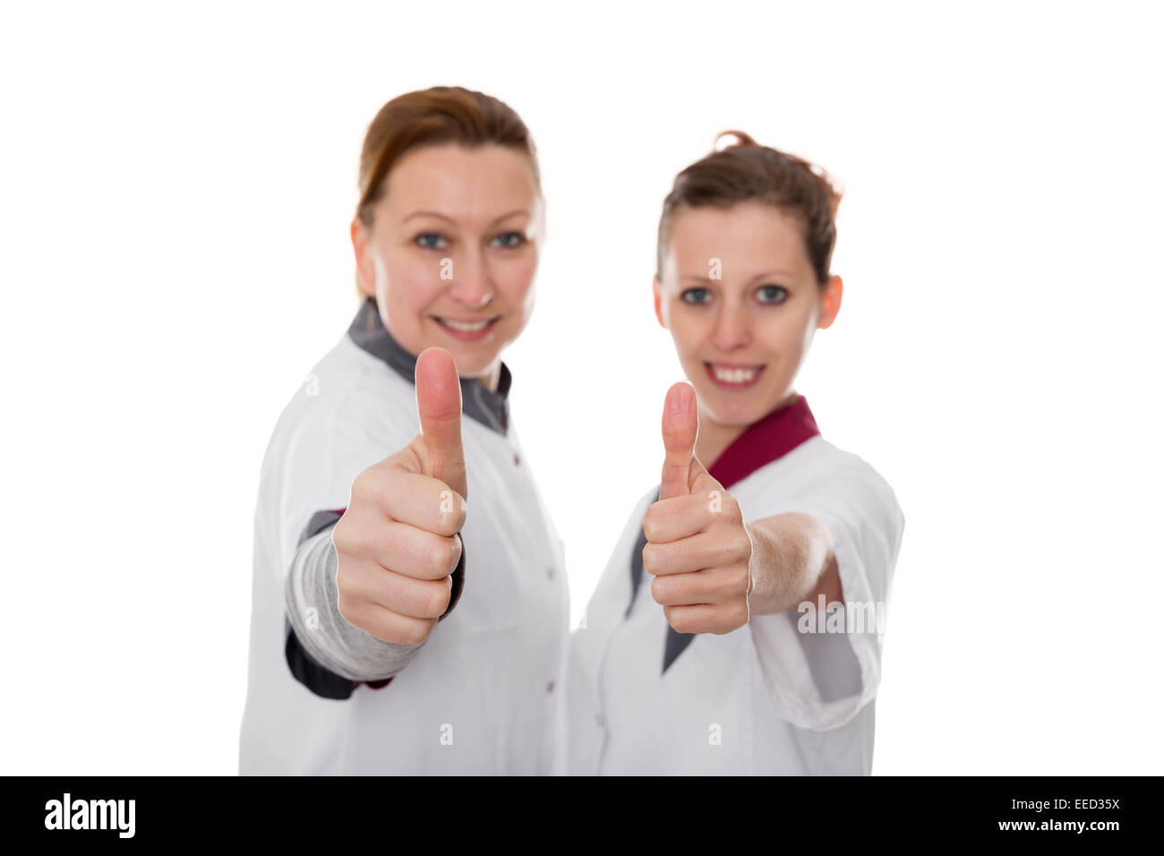 Deux infirmières montrant l'énergie et de succès, isolated on white Banque D'Images