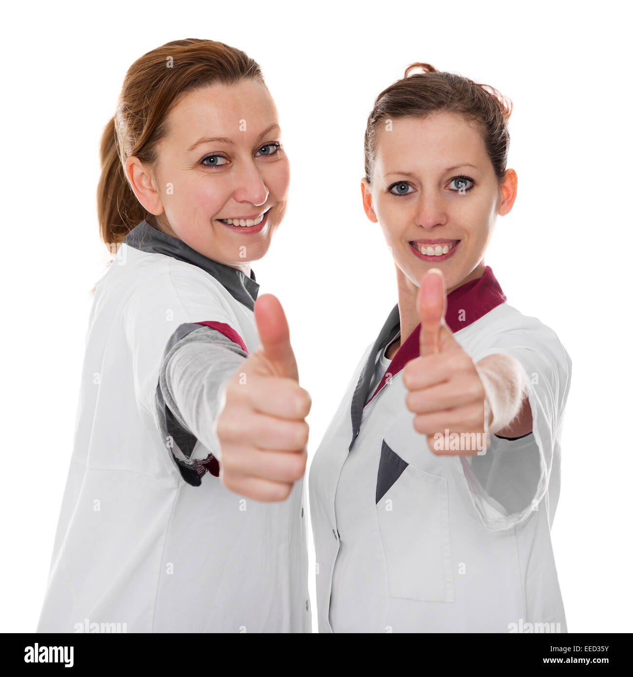 Deux femmes infirmières montrant l'énergie et de succès, isolated on white Banque D'Images