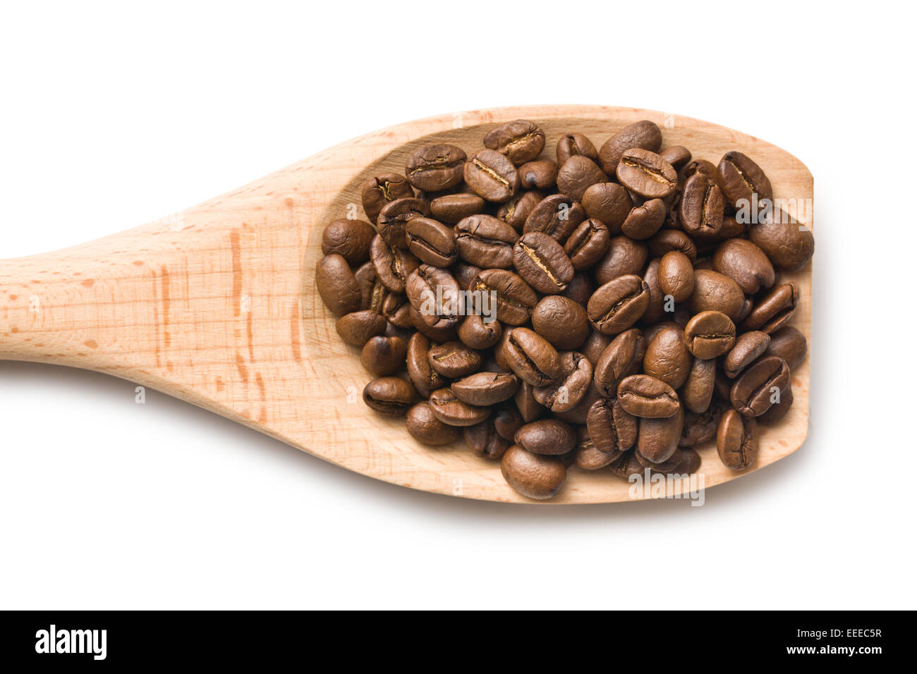 Les grains de café dans la cuillère en bois Banque D'Images