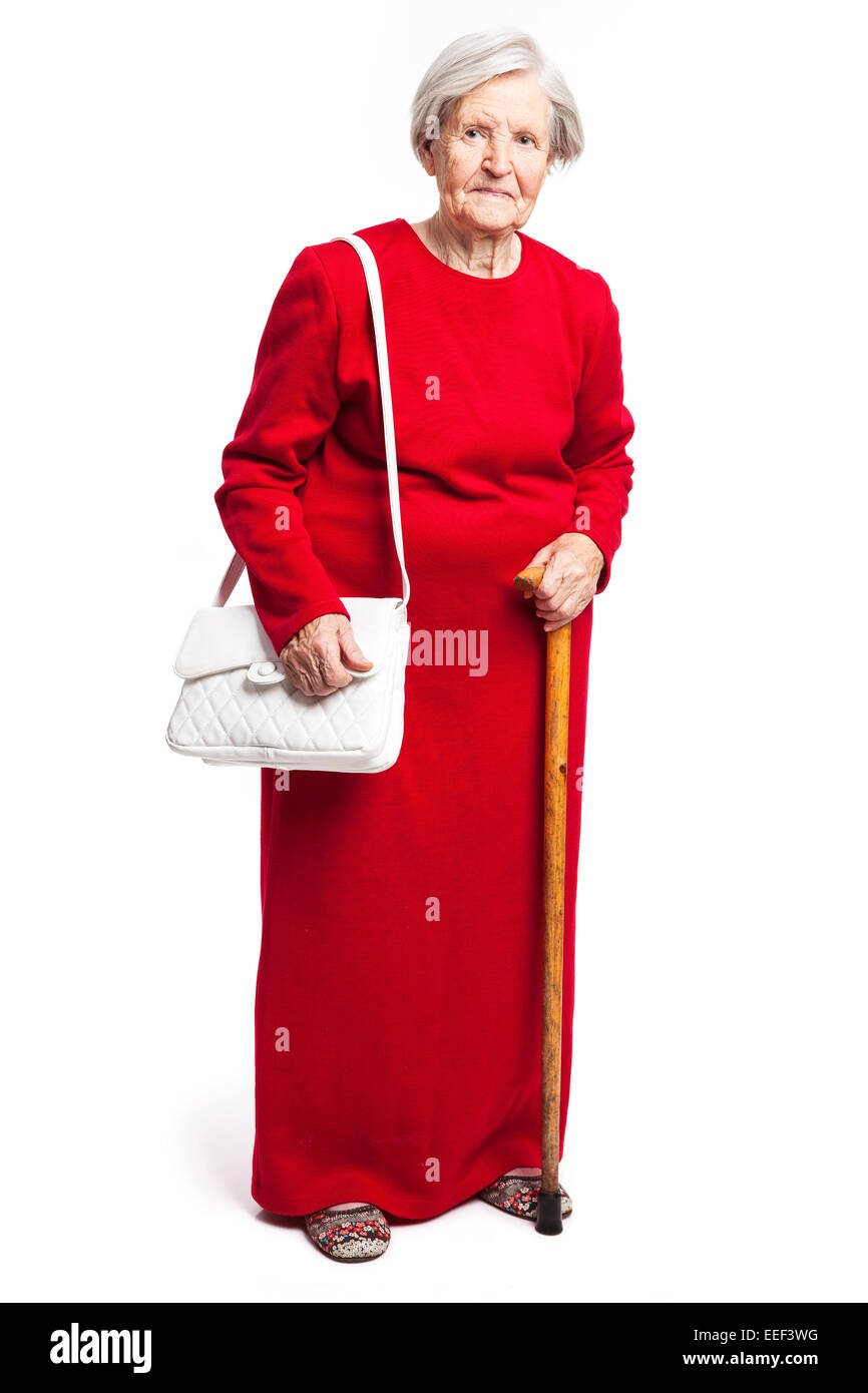 Senior woman with walking stick article over white Banque D'Images