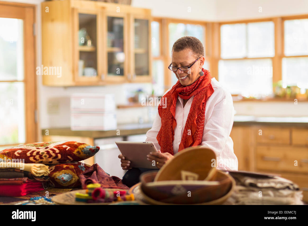 Plus mixed race woman using digital tablet in office Banque D'Images