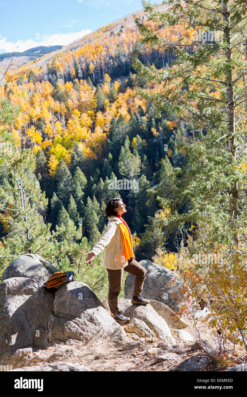 Mixed Race woman admiring scenic view in forest Banque D'Images