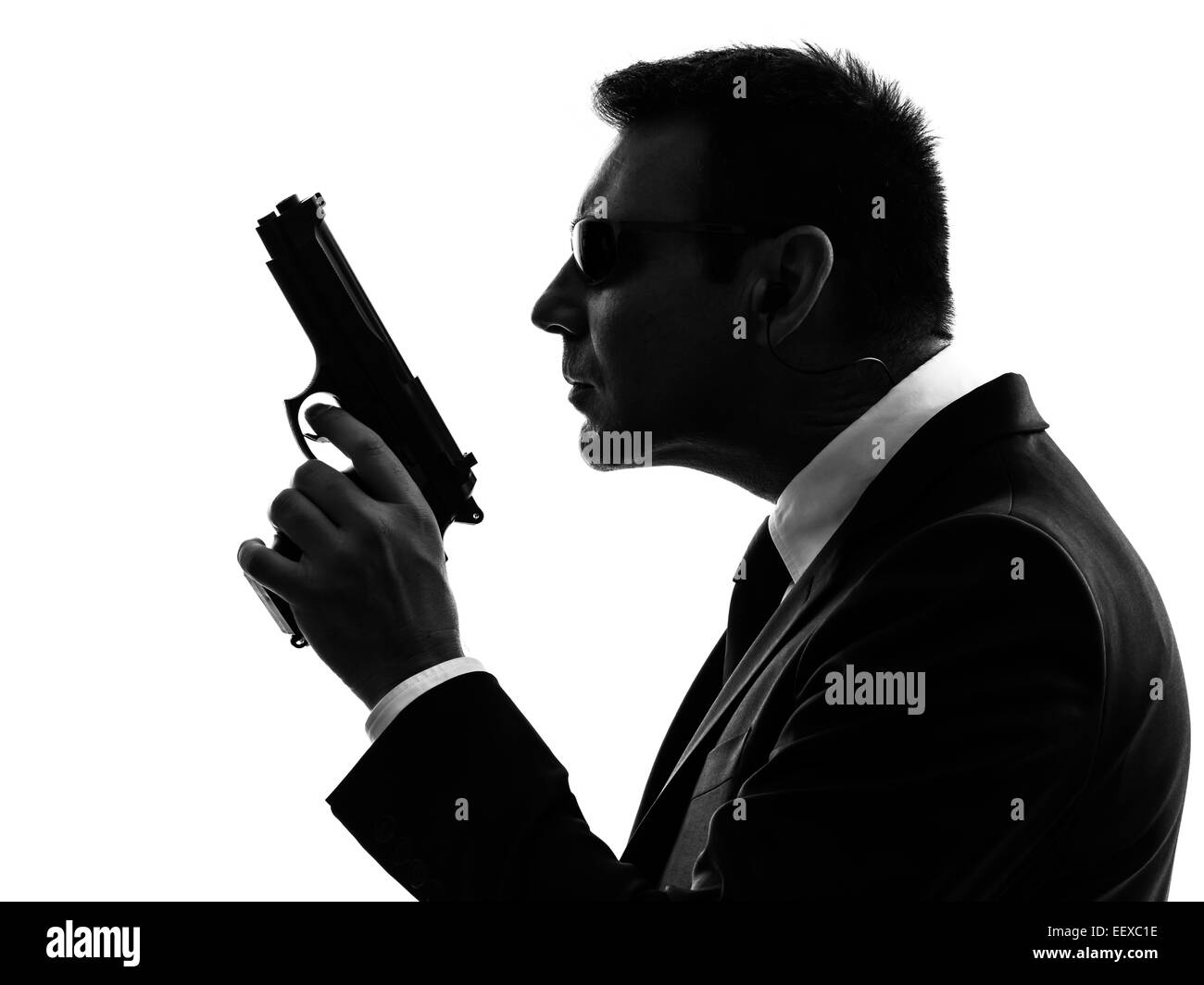 Un service secret agent de sécurité garde du corps homme en silhouette sur fond blanc Banque D'Images