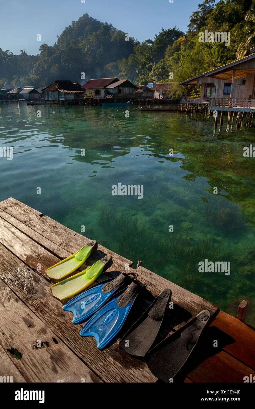 Des nageoires de plongée libre sur une jetée à Sawai, un village de pêcheurs qui se transforme en partie pour offrir l'écotourisme à North Seram, Maluku, Indonésie. Banque D'Images