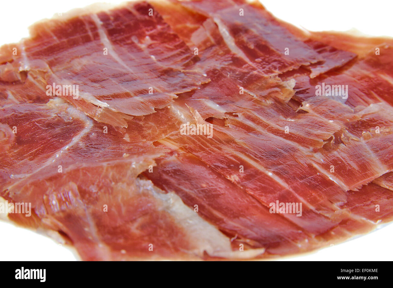 Gros plan du jambon serrano espagnol sur fond blanc Banque D'Images