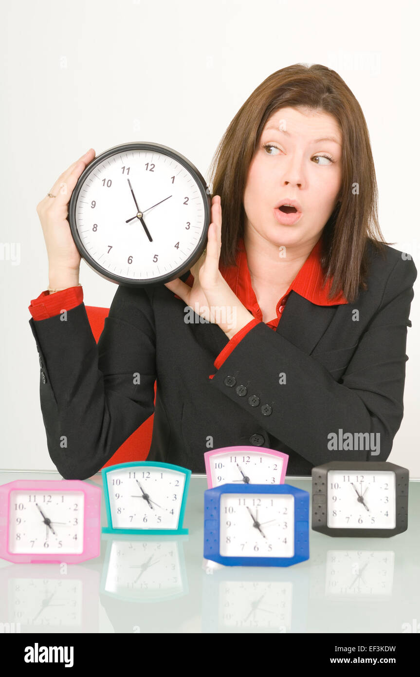 Businesswoman holding a clock Banque D'Images
