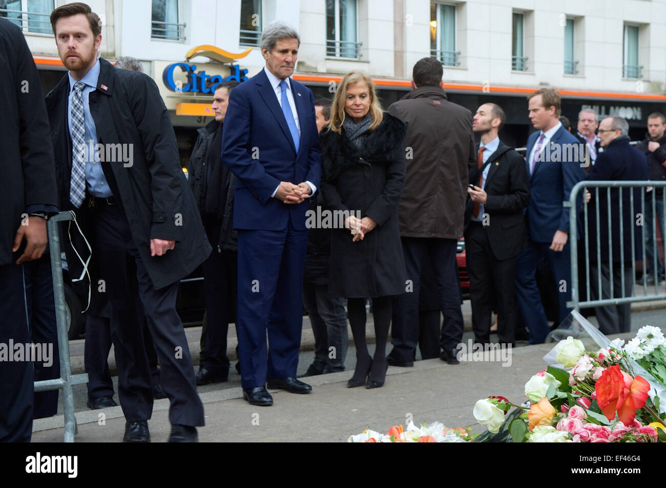 Le secrétaire d'Etat John Kerry et ambassadeur des États-Unis en France Jane Hartley regarder les fleurs qui s'mémorial improvisé sur le trottoir où le français policier Ahmed Merabet a été tué quand ils s'arrêtèrent dans tout Paris, France, le 16 janvier 2015, pour rendre hommage à ceux qui ont été tués la semaine dernière durant l'fusillades dans la capitale. Banque D'Images