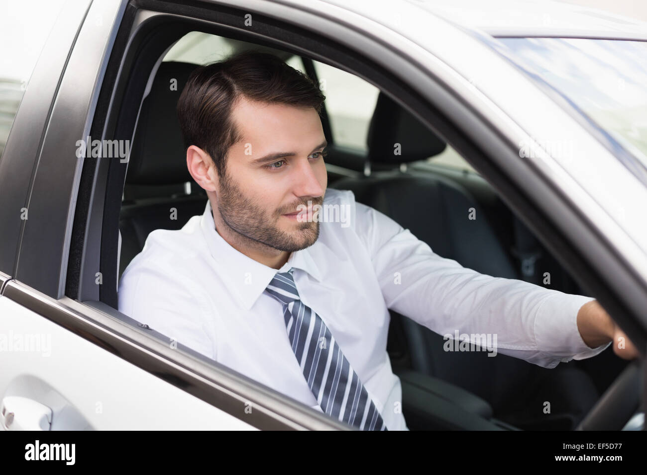 Jeune homme d'affaires dans le siège du conducteur. Banque D'Images