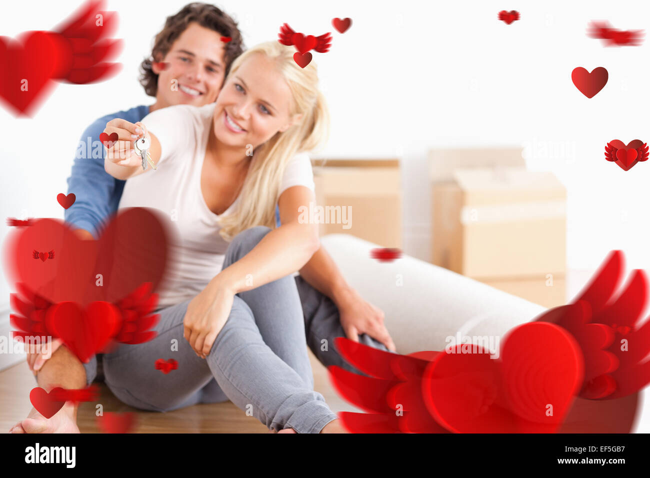 Image composite de femme assise avec son fiancé touches donnant Banque D'Images