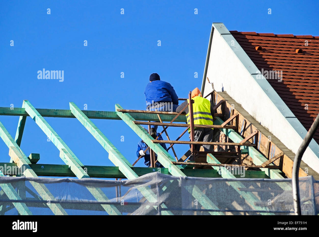 Les couvreurs travaillent à la construction d'une nouvelle maison Banque D'Images