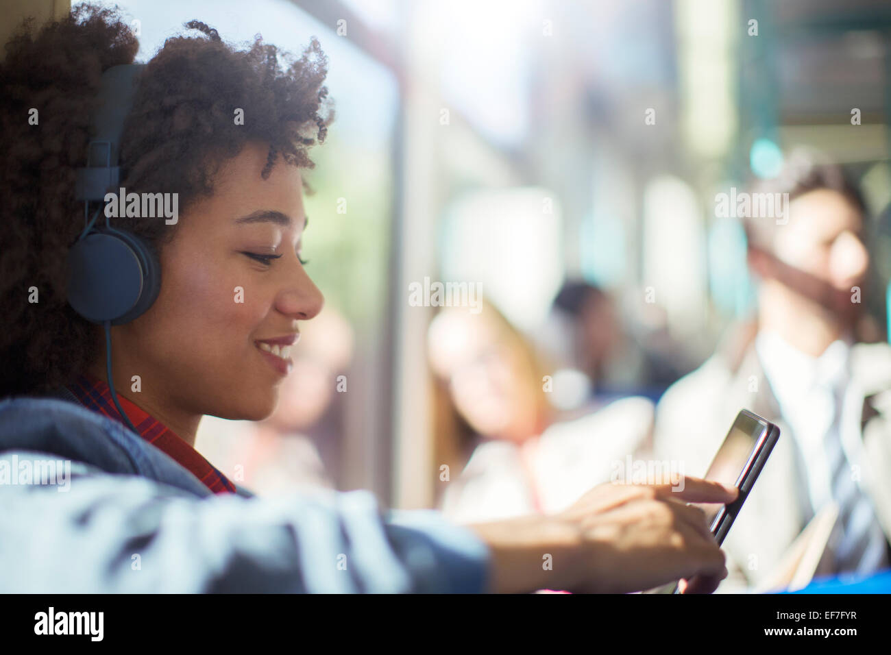 Woman using digital tablet on train Banque D'Images