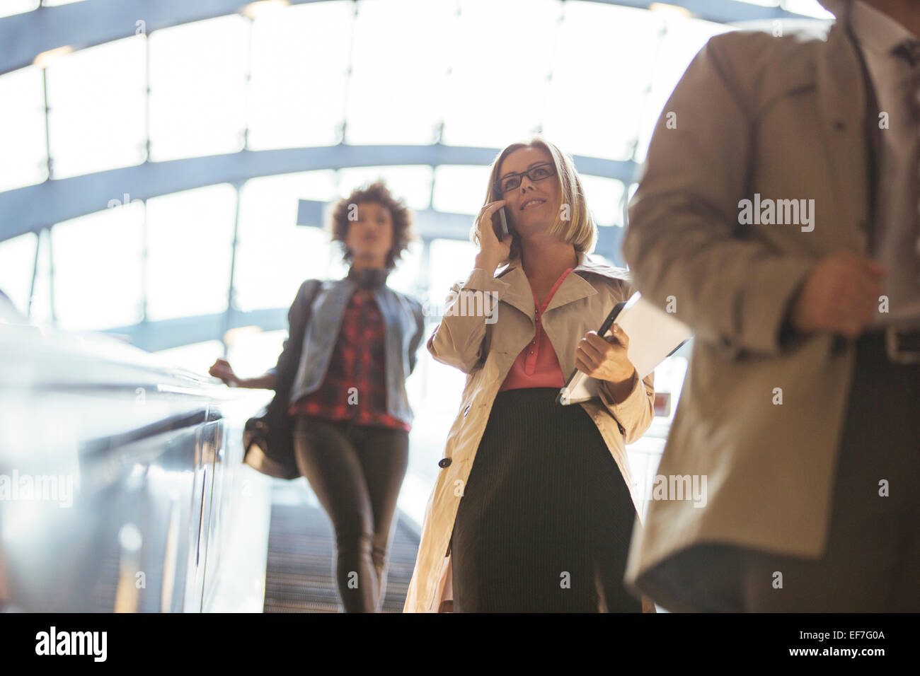 Low angle view of business people riding escalator Banque D'Images