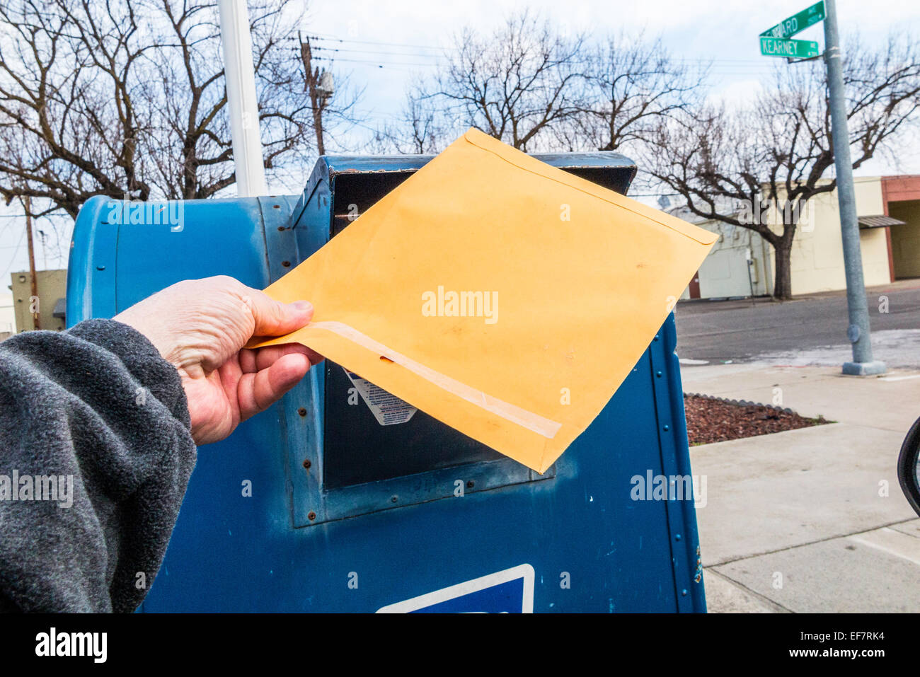 Un homme poster une lettre à un lecteur de mail box en Californie USA Banque D'Images