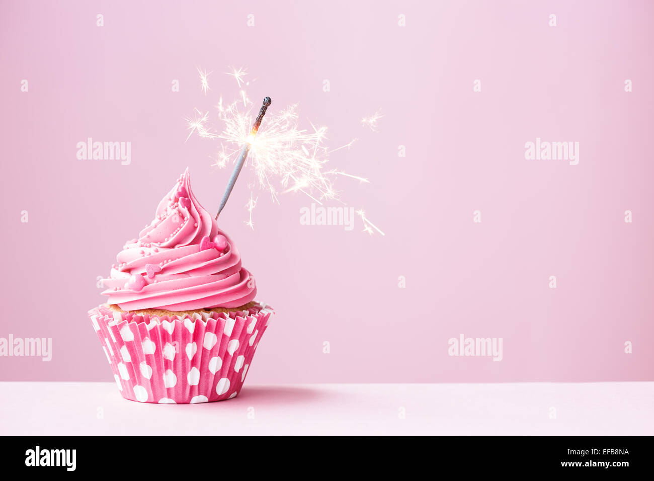 Cupcake rose décorée d'un sparkler Banque D'Images
