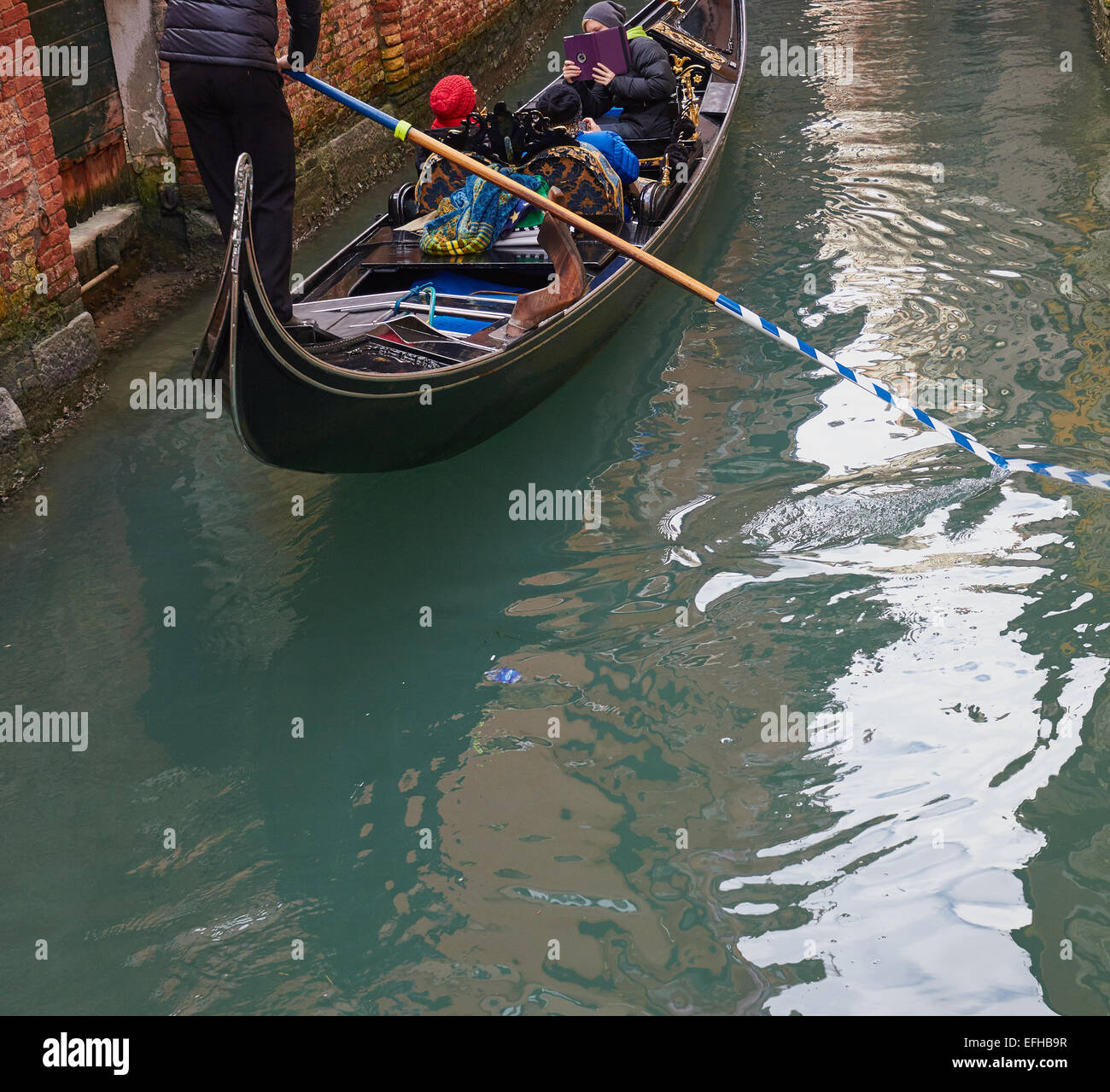 Aviron Gondolier les touristes sur une gondole, Venise, Vénétie, Italie, Europe. Banque D'Images