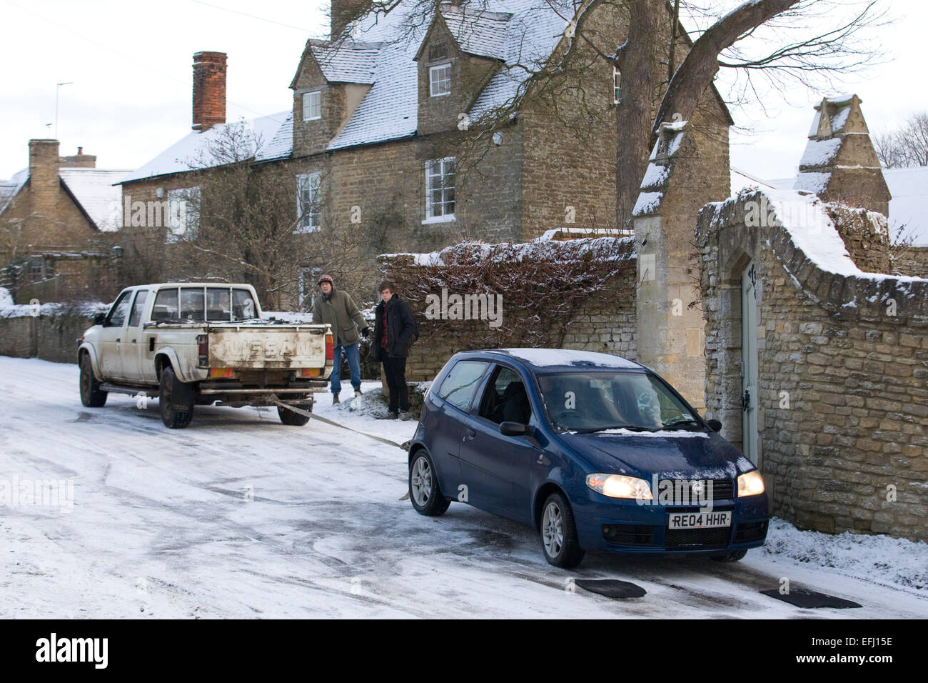 Car être remorqués hors de route glacée par un 4x4 pick up Banque D'Images