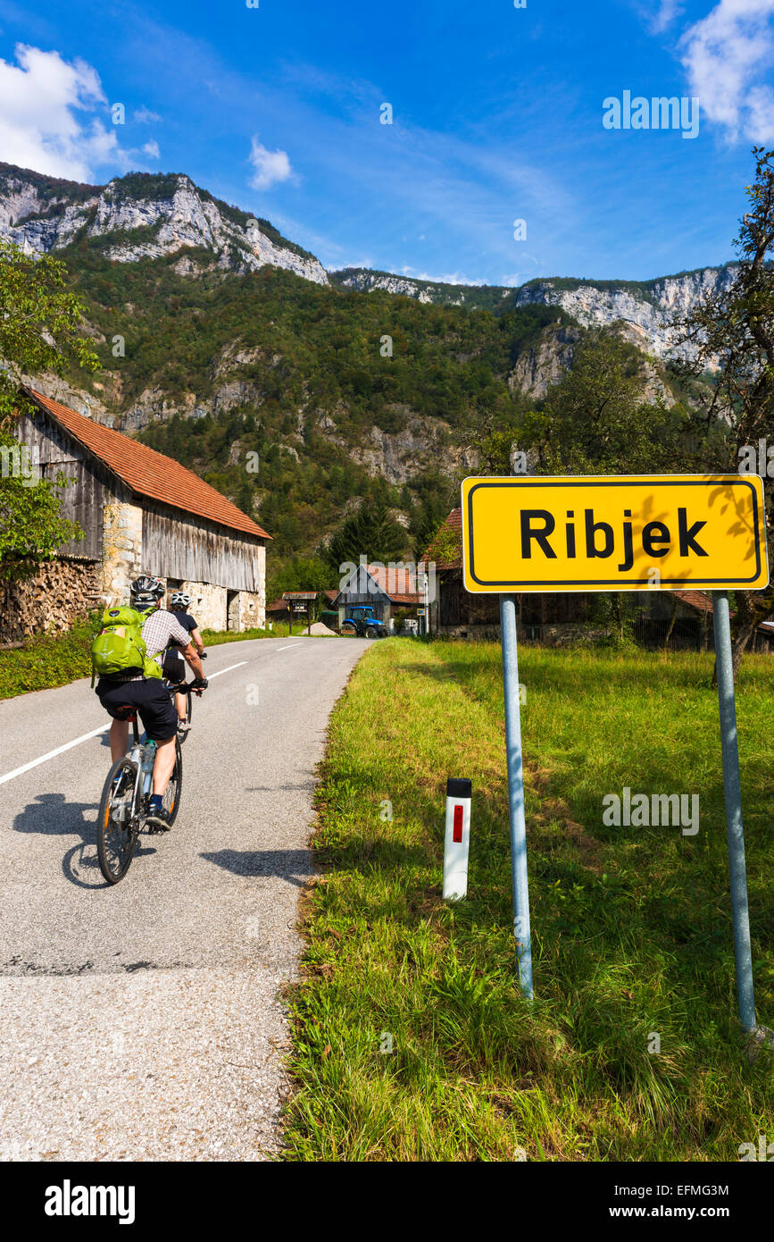 Les cyclistes d'entrer dans le village d'Ribjek, Slovénie Banque D'Images