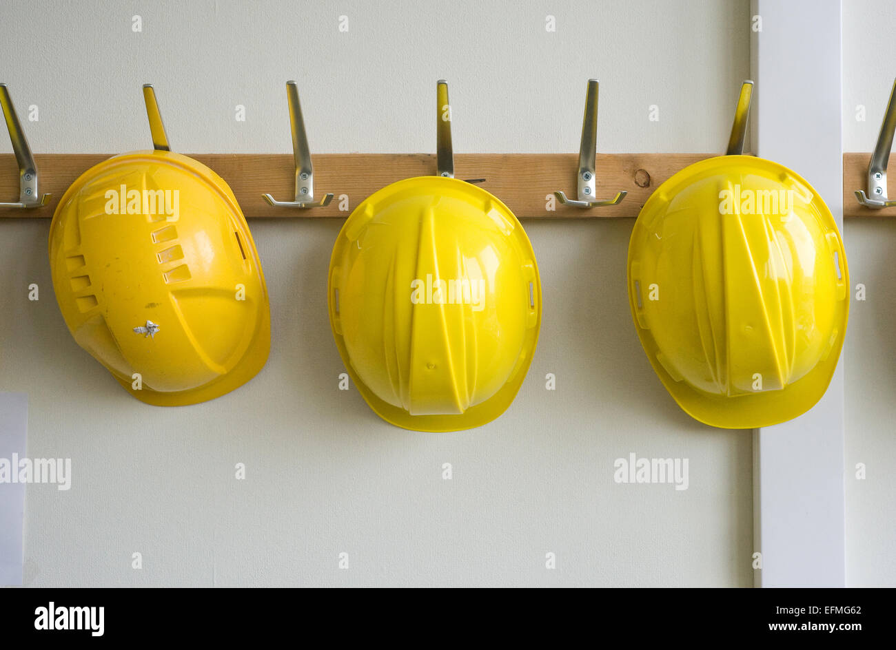 Deux casques accroché à des cintres sur un lieu de construction Banque D'Images