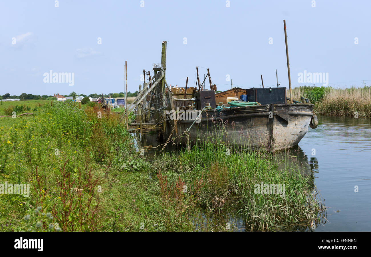 Péniche amarrée à l'abandon le long de la rive de la rivière Hull près du village de Tickton par un beau jour d'été, Yorkshire, UK. Banque D'Images
