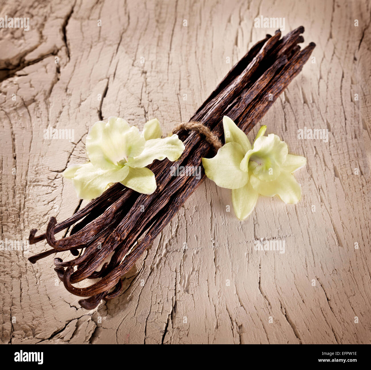 Tas de bâtons de vanille et de fleurs sur le vieux bois. Banque D'Images
