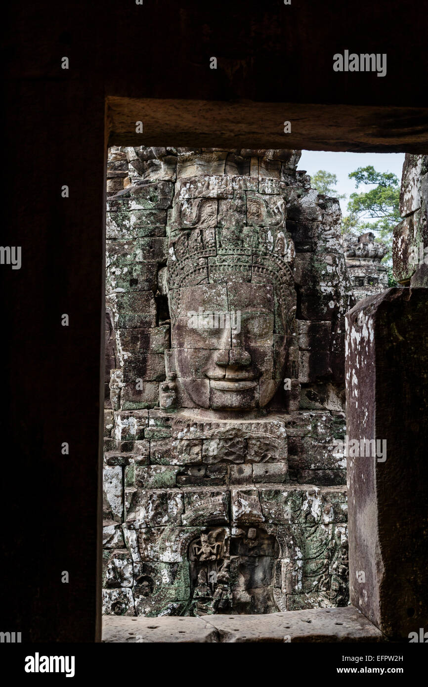 Bouddha visage sculpté dans la pierre au temple Bayon, Angkor Thom, Angkor, au Cambodge. Banque D'Images