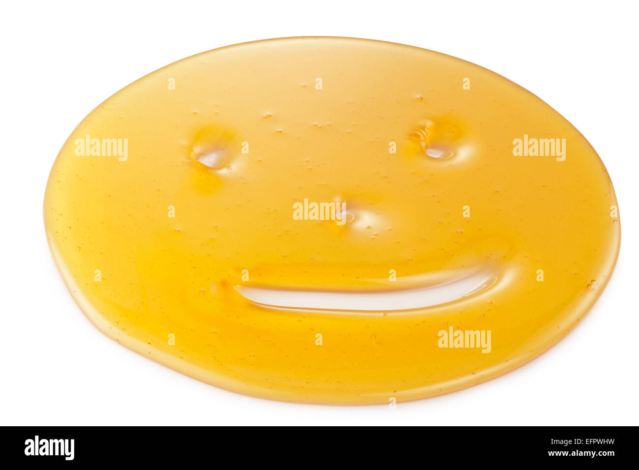 Des gouttelettes de miel sous la forme de smiley sur fond blanc. Banque D'Images