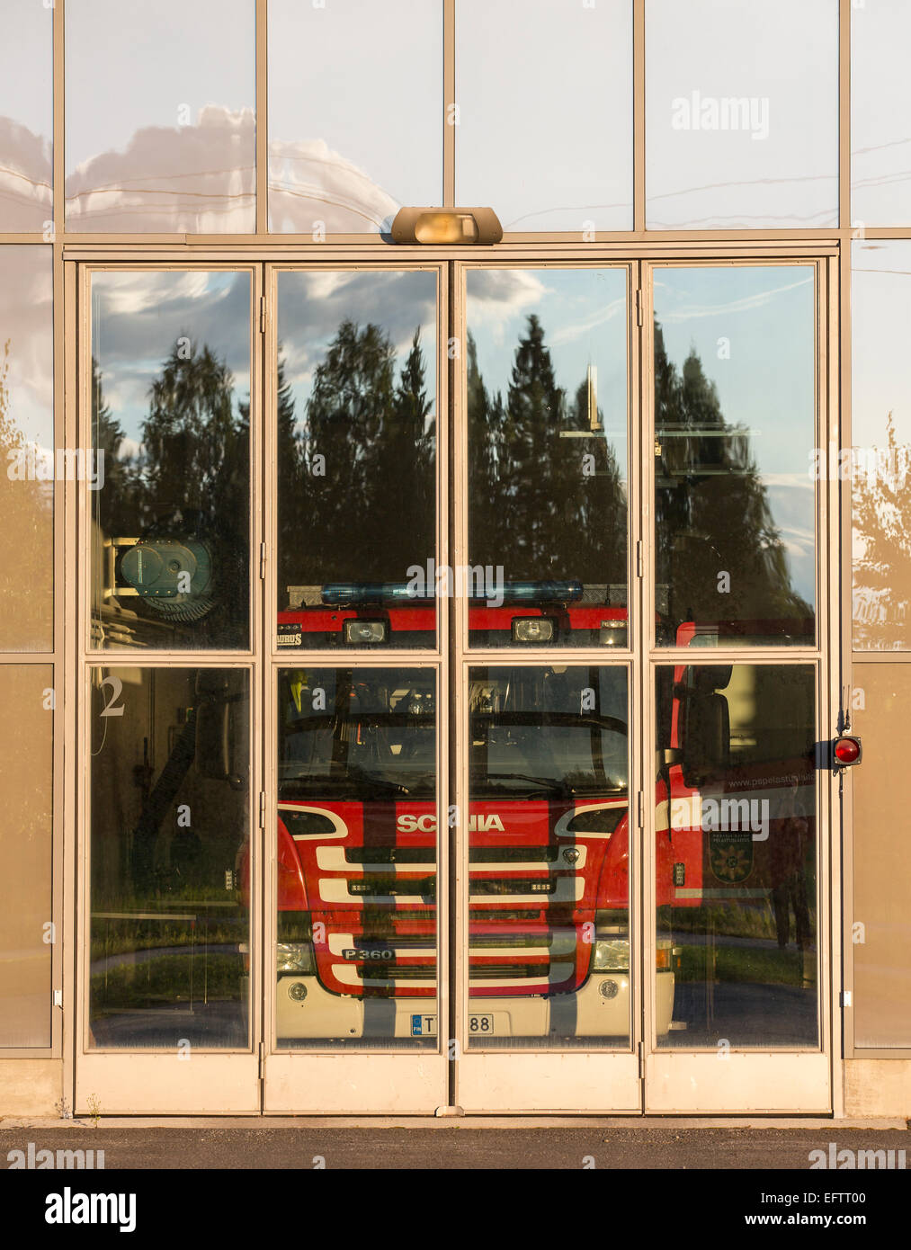 Camion à incendie derrière les portes en verre à la caserne de garage , Finlande Banque D'Images