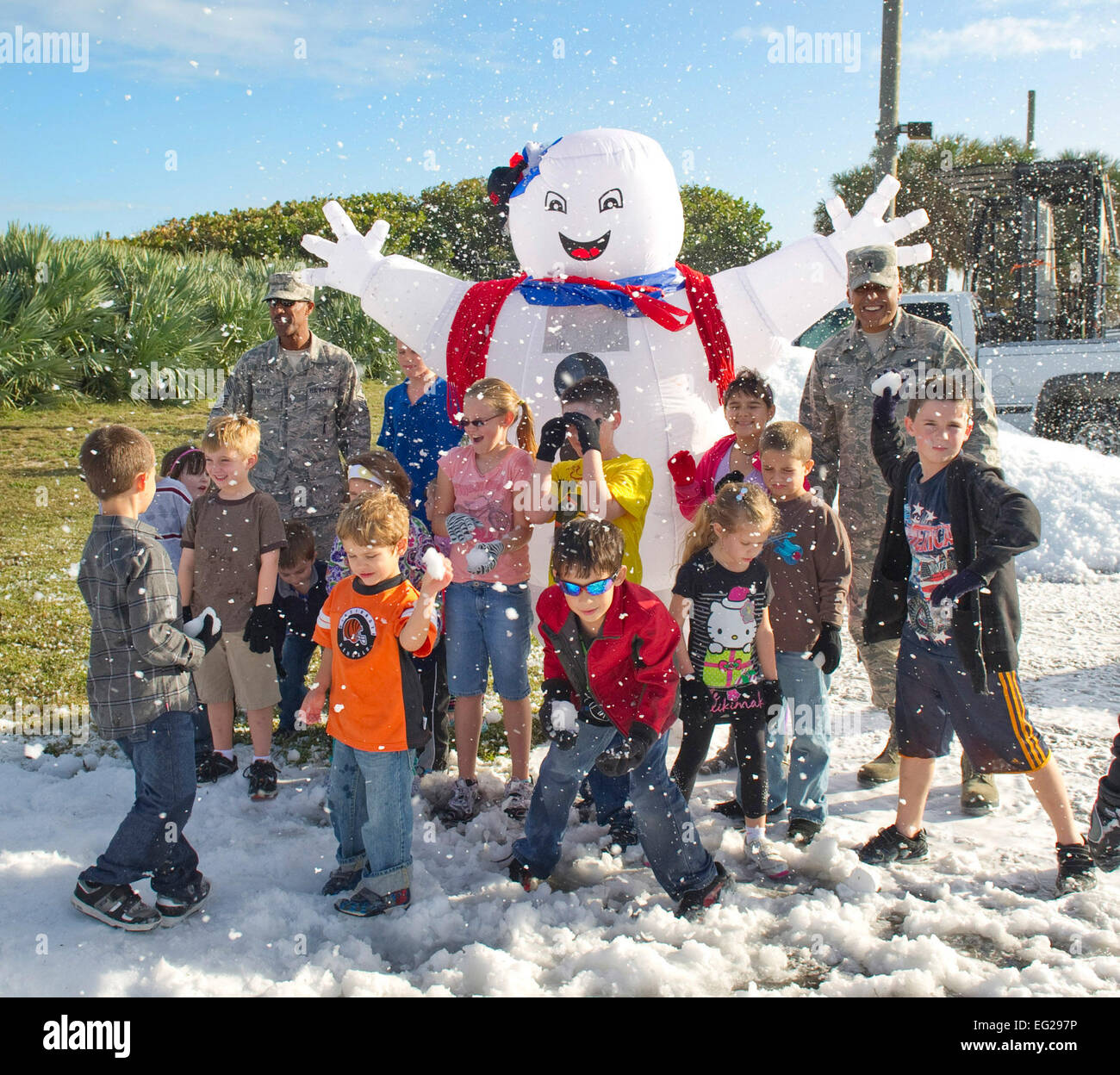 Le brig. Le général Anthony Dos de coton, chef droit Master Sgt. Herman Moyer en arrière à gauche et les enfants à partir de la 45e Escadre profiter de l'espace du vrai neige pendant les vacances fête à Patrick Air Force Base, en Floride, le 14 décembre 2012. Le coton est la 45e commandant SW et Moyer est le 45e commandement en chef SW. Banque D'Images