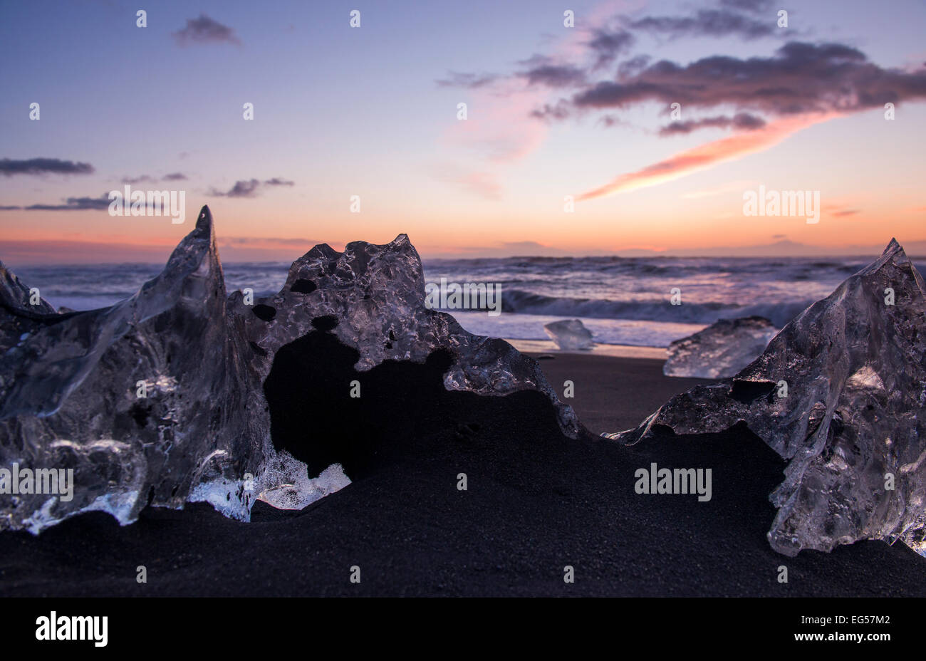 La glace de glacier échouée sur la plage de sable noir à Jokulsarlon en Islande. Banque D'Images