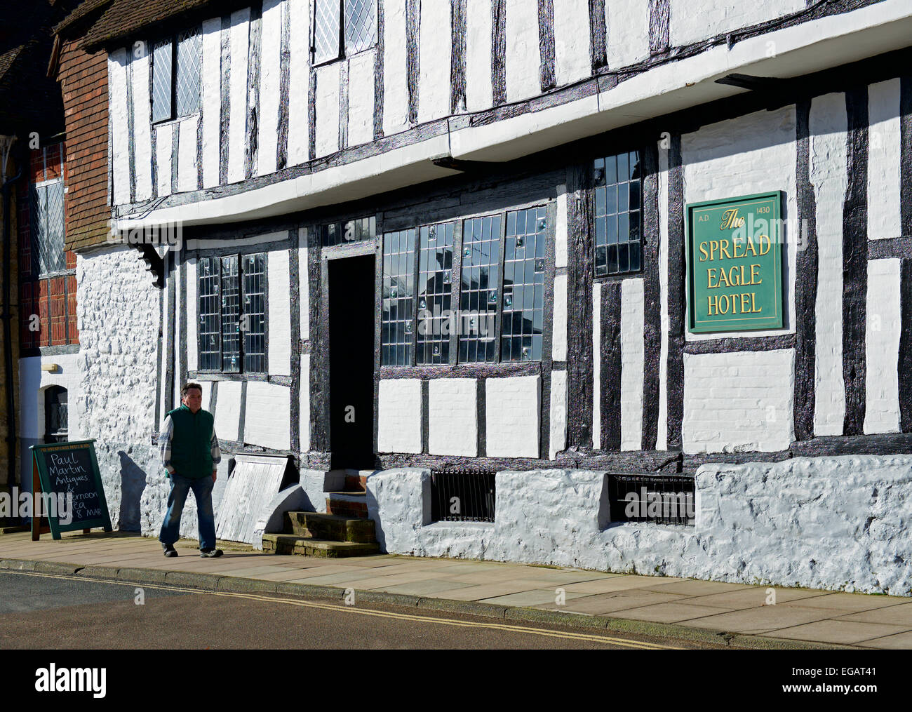 Homme marchant passé the Spread Eagle Hotel, Midhurst, West Sussex, Angleterre u Banque D'Images