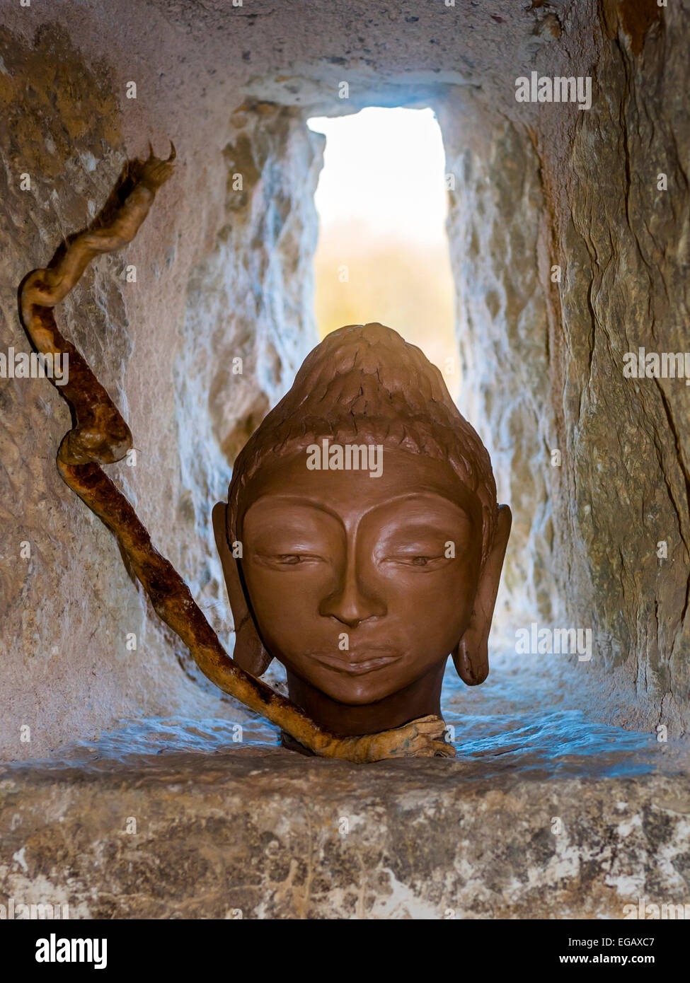 L'argile fait main tête de Bouddha en fenêtre niche - France. Banque D'Images