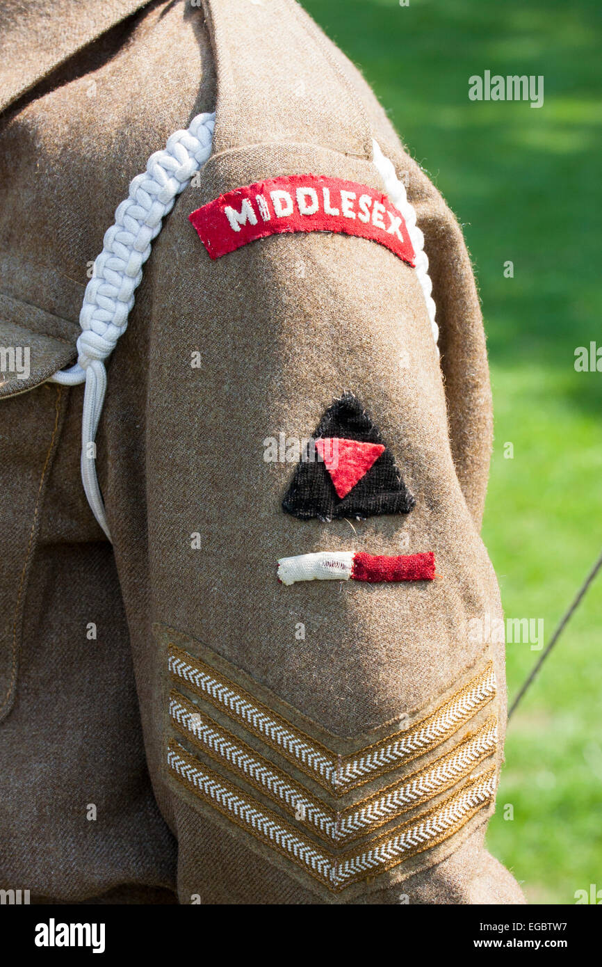 Gros plan des pièces d'uniforme, de bras et d'épaule de l'armée britannique, vers les années 1940. Le Sergent stipes et la plaque d'épaule du Middlesex. Banque D'Images