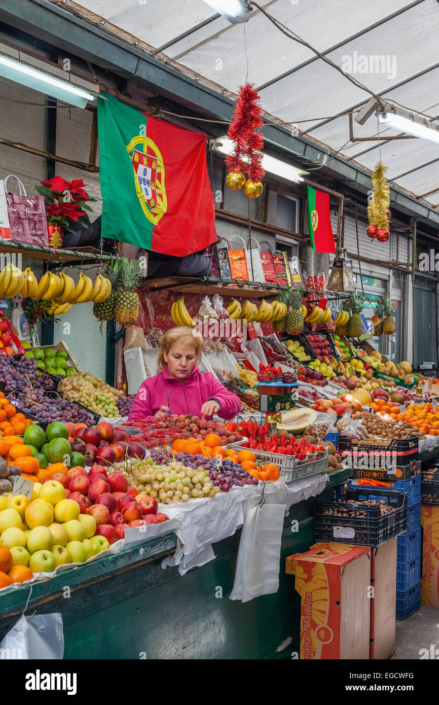 Porto, Portugal. Vendeur de fruits l'organisation et prendre soin de la parole à l'intérieur de l'historique marché Bolhão Banque D'Images